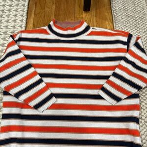 Maeve by Anthropologie Carys mock-neck sweater with orange and navy stripes.
